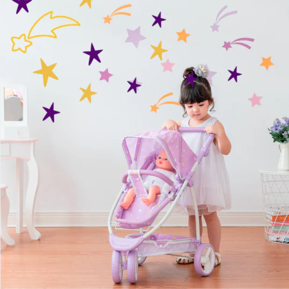 Little girl pushes a purple stroller with a baby doll sitting inside.