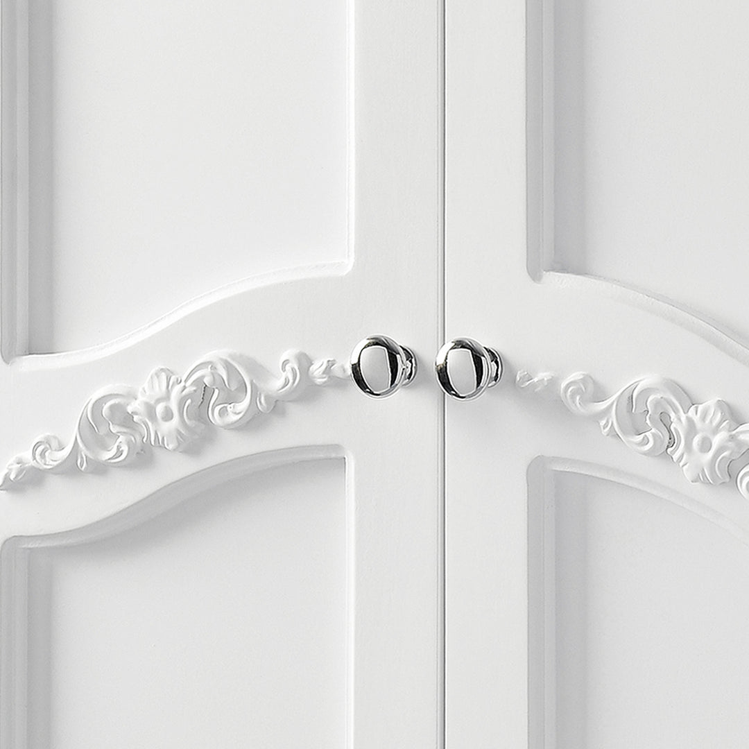 Close-up of chrome pull handles and decorative scrollwork on the cabinet handles